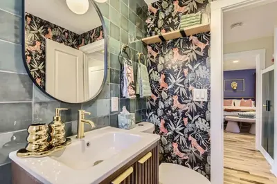 a bathroom with a sink and a mirror at The Denver Duo Two Homes, One Epic Stay in Denver