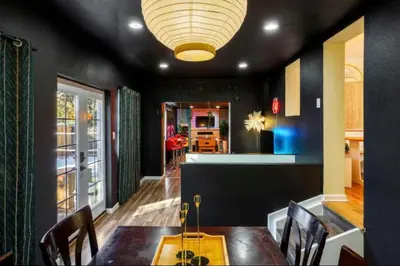 a dining room with a table and a kitchen at The Denver Duo Two Homes, One Epic Stay in Denver