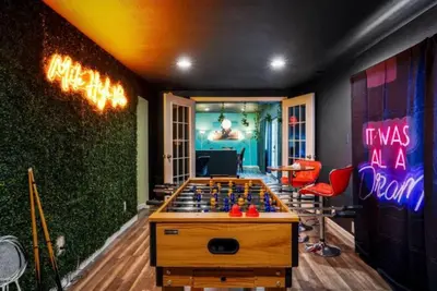 a room with a foosball table in the middle at The Denver Duo Two Homes, One Epic Stay in Denver