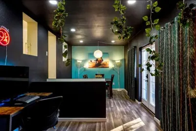 a restaurant with a bar with plants on the wall at The Denver Duo Two Homes, One Epic Stay in Denver