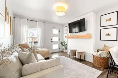 a living room with a couch and a tv at West Denver Radiance Light and Bright 3BR retreat in Denver