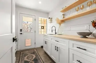 a kitchen with white cabinets and a sink at West Denver Radiance Light and Bright 3BR retreat in Denver