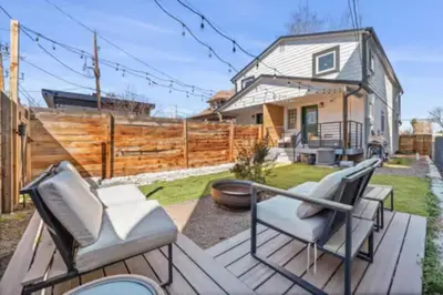 a backyard with two chairs and a fence at West Denver Radiance Light and Bright 3BR retreat in Denver