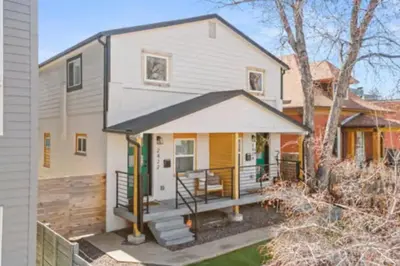 a home with a porch and a house at West Denver Radiance Light and Bright 3BR retreat in Denver