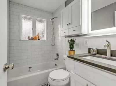 a white bathroom with a toilet and a sink at Cozy Hot Tub Escape - Pool Table & Home Theater in Arvada