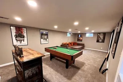 a living room with a pool table and a couch at Cozy Hot Tub Escape - Pool Table & Home Theater in Arvada