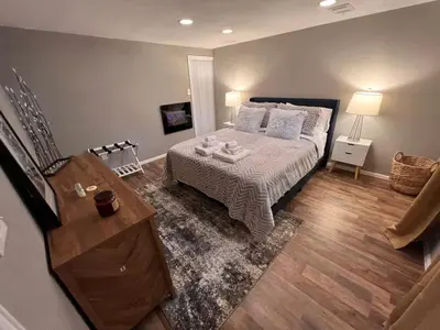a bedroom with a bed and a table in it at Cozy Hot Tub Escape - Pool Table & Home Theater in Arvada