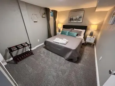 a bedroom with a bed with two towels on it at Cozy Hot Tub Escape - Pool Table & Home Theater in Arvada