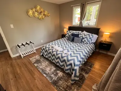 a bedroom with a bed with a blue and white comforter at Cozy Hot Tub Escape - Pool Table & Home Theater in Arvada