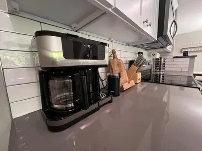a kitchen with a coffee maker on a counter at Cozy Hot Tub Escape - Pool Table & Home Theater in Arvada