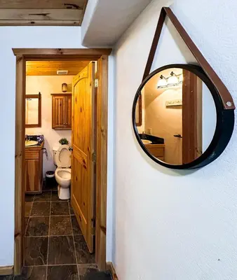 a bathroom with a mirror and a toilet at The Carriage House, Walk to River & Lake, In Town in Grand Lake