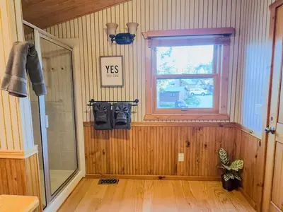 a room with a shower and a window in a room at The Carriage House, Walk to River & Lake, In Town in Grand Lake