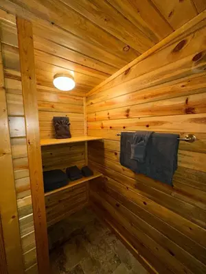 a wooden sauna with towels on a wooden wall at The Red Bears Den, Walk to River & Lake, In Town in Grand Lake