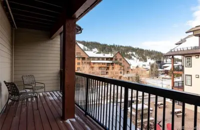 a balcony with a chair and a view of a town at Winter Park Village Homebase in Winter Park