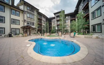a pool in the middle of a courtyard with buildings at Winter Park Village Homebase in Winter Park