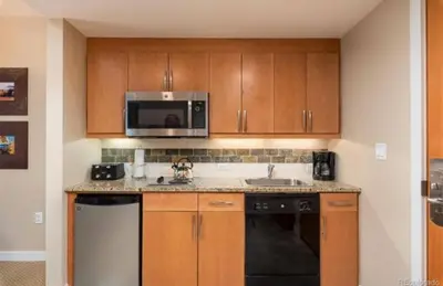 a kitchen with a sink and a microwave at Winter Park Village Homebase in Winter Park