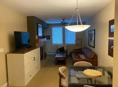 a living room with a couch and a table at Winter Park Village Homebase in Winter Park