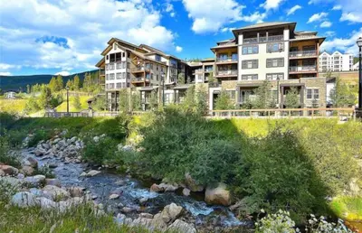 a large apartment building next to a river at Winter Park Village Homebase in Winter Park