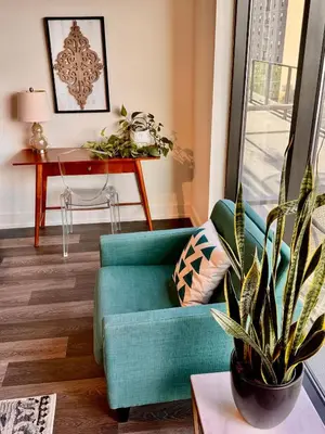 a living room with a blue couch and a table at Lux Living in Cherry Creek Rooftop Pool Parking in Denver