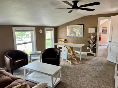 a living room with a couch and a table and chairs at Historic Home with Farm Fresh Eggs in Denver in Denver