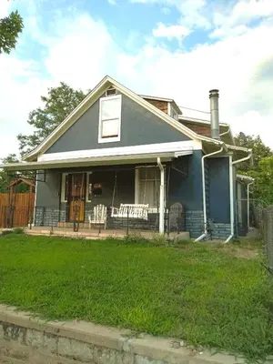a blue house with a porch and a yard at Historic Home with Farm Fresh Eggs in Denver in Denver