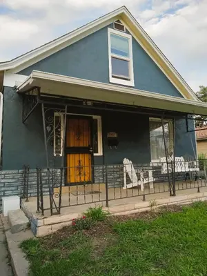 a blue house with a porch with a wooden door at Historic Home with Farm Fresh Eggs in Denver in Denver