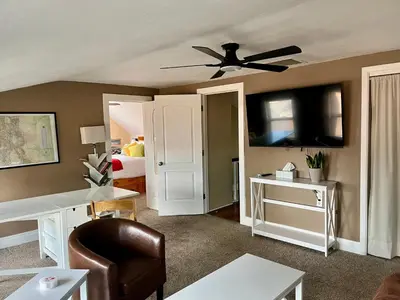 a living room with a ceiling fan and a bedroom at Historic Home with Farm Fresh Eggs in Denver in Denver