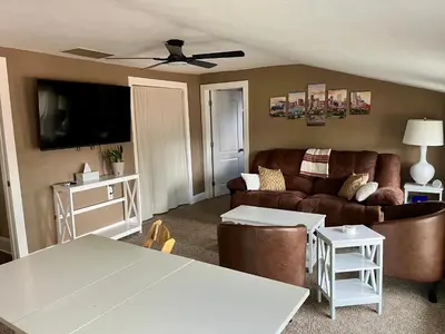 a living room with a couch and a table at Historic Home with Farm Fresh Eggs in Denver in Denver