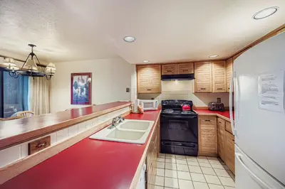 a kitchen with a sink and a stove top oven at Frostfire B19 condo in Snake River Health Services Incorporated Heliport