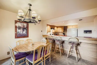 a kitchen and dining room with a table and chairs at Frostfire B19 condo in Snake River Health Services Incorporated Heliport