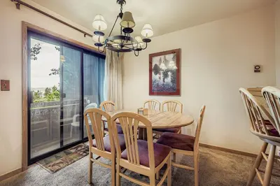 a dining room with a table and chairs and a window at Frostfire B19 condo in Snake River Health Services Incorporated Heliport