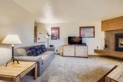 a living room with a couch and a tv at Frostfire B19 condo in Snake River Health Services Incorporated Heliport