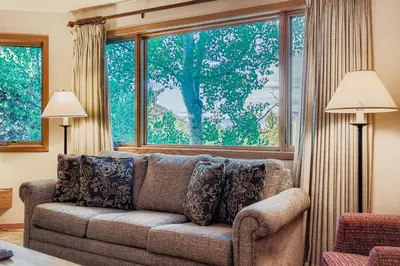 a living room with a couch and a large window at Frostfire B19 condo in Snake River Health Services Incorporated Heliport