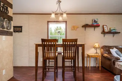 a dining room table with chairs and a couch at Zig Zag Retreat, Cozy, Pet-Friendly Escape Near Lakes, and Rocky Mountain National Park in Grand Lake