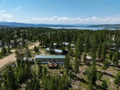 an aerial view of a farm with a house and trees at Zig Zag Retreat, Cozy, Pet-Friendly Escape Near Lakes, and Rocky Mountain National Park in Grand Lake