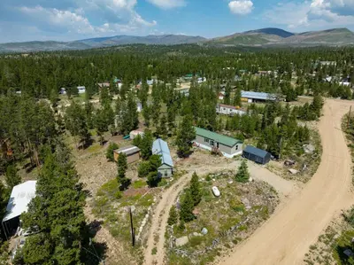 an aerial view of a farm with trees and a road at Zig Zag Retreat, Cozy, Pet-Friendly Escape Near Lakes, and Rocky Mountain National Park in Grand Lake