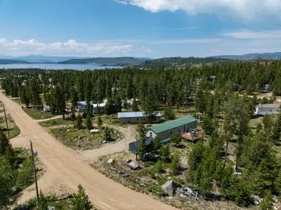 an aerial view of a forest with a building and a road at Zig Zag Retreat, Cozy, Pet-Friendly Escape Near Lakes, and Rocky Mountain National Park in Grand Lake