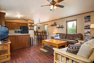 a living room with a couch and a table at Zig Zag Retreat, Cozy, Pet-Friendly Escape Near Lakes, and Rocky Mountain National Park in Grand Lake
