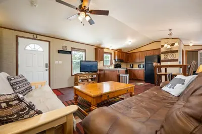 a living room with a couch and a table at Zig Zag Retreat, Cozy, Pet-Friendly Escape Near Lakes, and Rocky Mountain National Park in Grand Lake