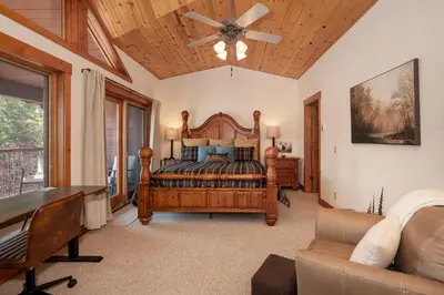 a bedroom with a bed and a ceiling fan at Beacon Landing Condo, Lakefront on Lake Granby, Luxurious Quality with Marina Right Outside in Grand Lake