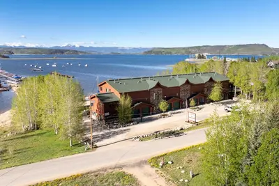 an aerial view of a resort with a lake at Beacon Landing Condo, Lakefront on Lake Granby, Luxurious Quality with Marina Right Outside in Grand Lake