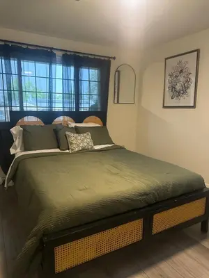 a large bed in a room with windows at Relax & Recharge, Peaceful Home in Northglenn