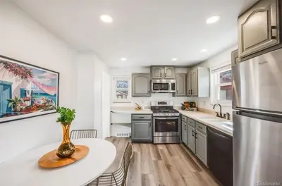 a kitchen with stainless steel appliances and a table at Relax & Recharge, Peaceful Home in Northglenn
