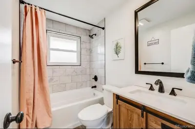 a bathroom with a tub and a toilet and a sink at Relax & Recharge, Peaceful Home in Northglenn