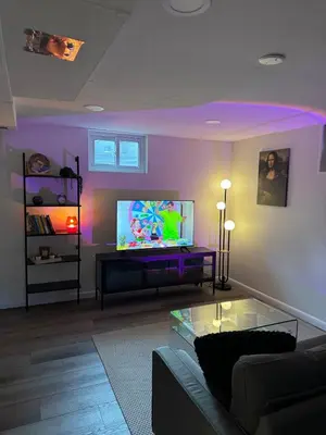 a living room with a couch and a flat screen tv at Relax & Recharge, Peaceful Home in Northglenn