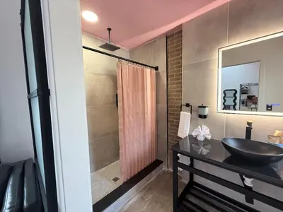 a bathroom with a sink and a shower at BIG little Hotel in Denver