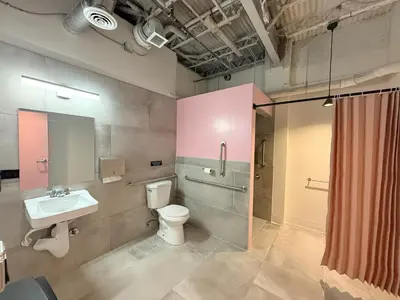 a bathroom with a toilet and a sink and a shower at BIG little Hotel in Denver