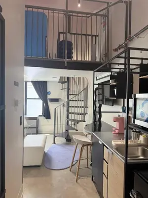 a room with a bunk bed and a living room at BIG little Hotel in Denver