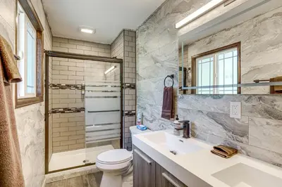 a bathroom with a sink and a toilet and a shower at Pet-Friendly Retreat with Fenced Yard in Aurora in Aurora