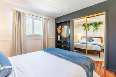 a bedroom with a bed and a mirror at Spacious 5BR, Epic Backyard, Perfect Gatherings in Arvada